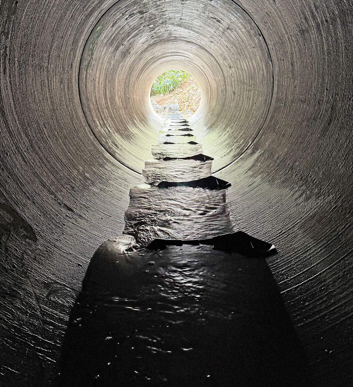 FlexiBaffles installed inside a round concrete culvert to slow water flow and improve fish migration